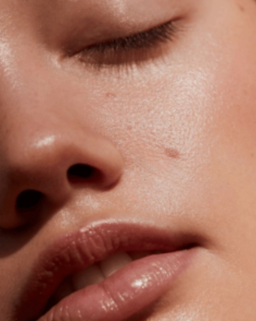 Soft-lit image of glowing, makeup-free skin — promoting skin confidence and holistic wellness.