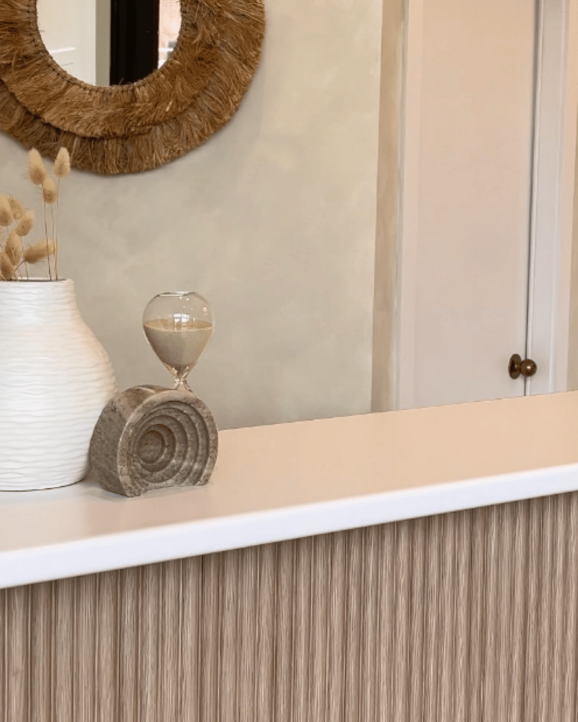 Spa reception counter with natural decor and soft lighting — welcoming guests into a holistic wellness space.