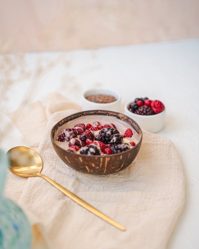 A vibrant berry smoothie bowl adorned with fresh berries in a natural setting.